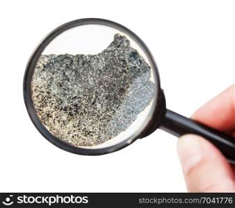 view of rough peridotite mineral through magnifier isolated on white background