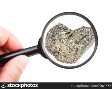 view of rough peridotite rock through magnifier isolated on white background