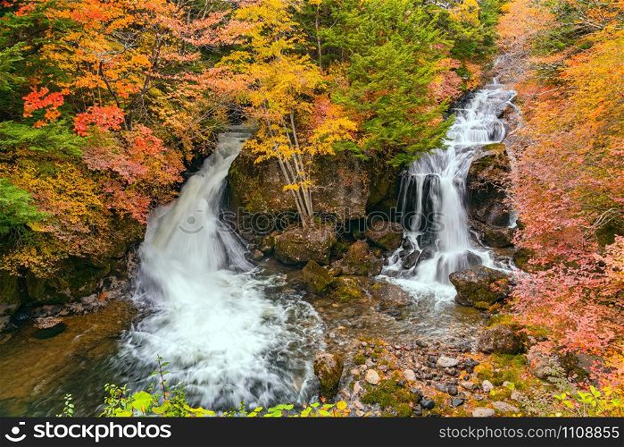 View of Ryuzu Waterfalls with the colorful foliage of autumn season forest in Nikko City, Tochigi Prefecture, Japan.