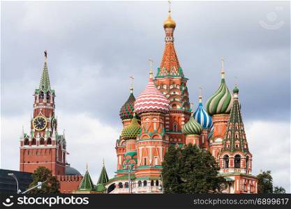 view of Saint Basil Cathedral (Pokrovsky Cathedral) and Spasskaya clock Tower of Moscow Kremlin on Red Square from Zaryadye district in september