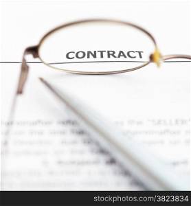 view of sales contract through eyeglasses close up
