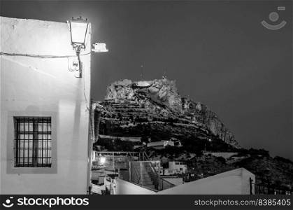 View of Santa Barbara Castle from Santa Cruz neighborhood, in the old Mediterranean town of Alicante, Spain. Black and white image