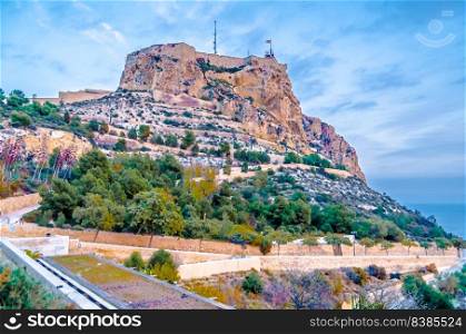 View of Santa Barbara Castle from the town of Alicante, Spain. Colorful illustration