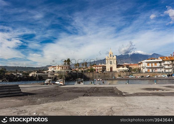 View of Sea port in sicily whit volcano Etna in background