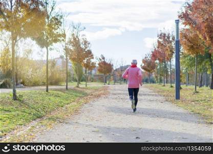 View Of Senior Man Jogging Through Park
