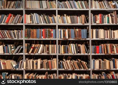 View of shelves with old books in library
