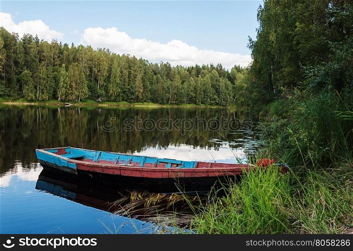 View of Shuya River and an old wooden boat. Karelia, Russia. Sunny summer day