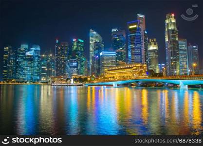 View of Singapore Downtown Core reflecting in a river at night