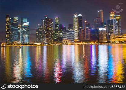 View of Singapore Downtown reflecting in a river at night