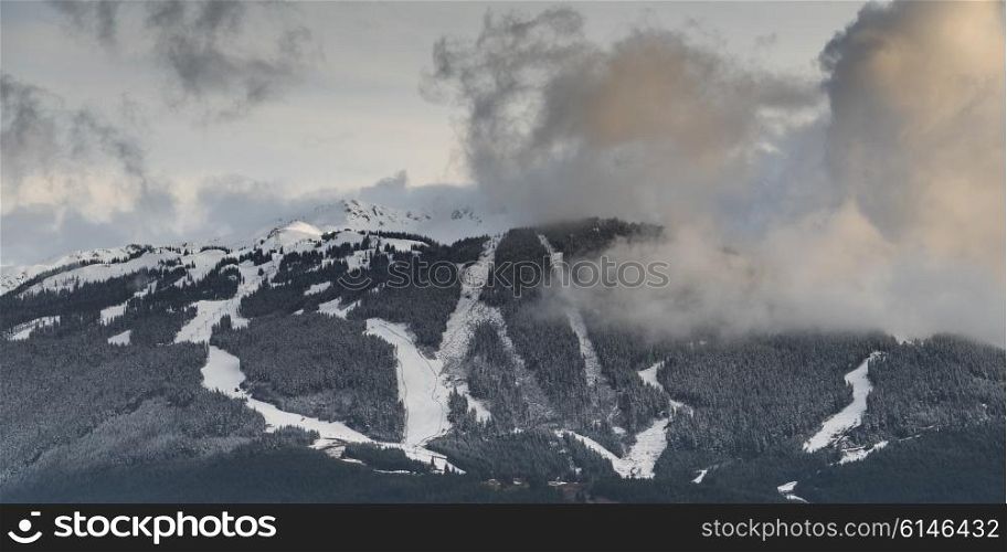 View of ski slopes on snowcapped mountains in winter, British Columbia, Canada