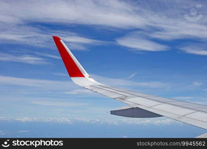 View of sky, cloud and wing from airplane window