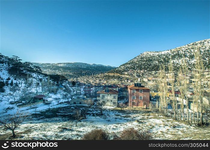 View of snow covered houses at Sertavul mountain pass in a snow cold winter day,Mersin,Turkey. View of snow covered houses at Sertavul mountain pass