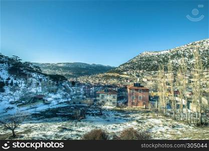 View of snow covered houses at Sertavul mountain pass in a snow cold winter day,Mersin,Turkey. View of snow covered houses at Sertavul mountain pass