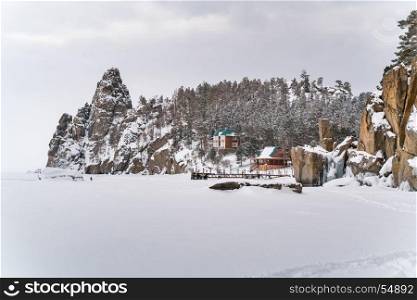 View of snow mountain and a village in Frozen Lake Baikal during snow fall