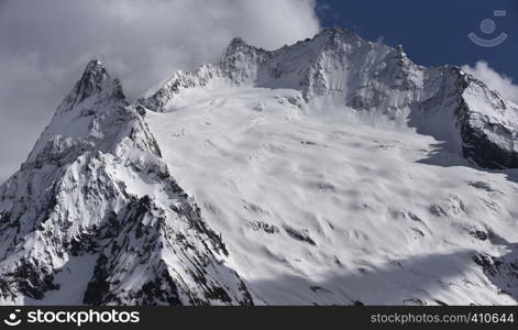 View of Snow Mountain Range Landscape with Blue Sky. Russia, Caucasus.