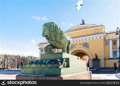 view of statue of lion and Admiralty building. view of bronze statue of Guard lion and old Admiralty building on Admiralty Embankment in Saint Petersburg city in march