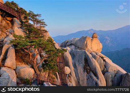 View of stones and rock formations from Ulsanbawi rock peak on sunset with staircase. Seoraksan National Park, South Corea. View from Ulsanbawi rock peak on sunset. Seoraksan National Park, South Corea