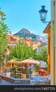 View of street in Plaka district in the old town of Athens, Greece - picturesque cityscape with city skyline