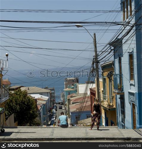 View of street with houses towards ocean, Valparaiso, Chile