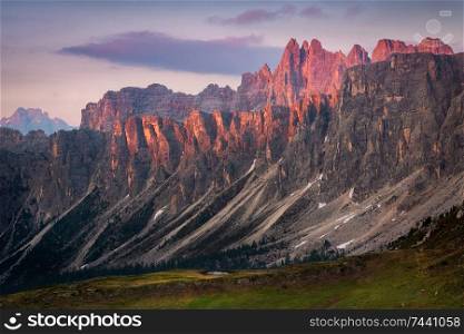 view of sunset in summer on mountain range Lastoni di Formin and Croda da Lago from Passo di Giau, Colle Santa Lucia, Dolomites, Italy. sunset in summer on mountain range Lastoni di Formin and Croda da Lago, Dolomites, Italy