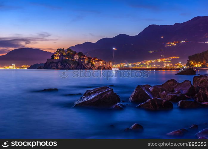 View of Sveti Stefan from the beach in Monenegro at sunset. Sveti Stefan at sunset