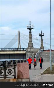 View of the Akmens bridge from the 11th November Embankment. Stairs to the stone bridge and lanterns in Riga, Latvia. Behind the Akmens bridge- Vansu bridge. Stone bridge in Riga city.