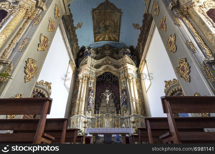 View of the altarpiece and ceiling of the central chapel of the Baroque Church of Saint Peter in the city of Gouveia, Beira Alta, Portugal