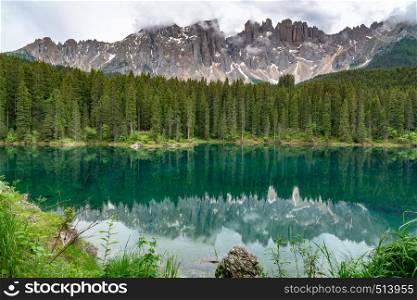 View of the beautiful Mount Latemar in Dolomites at South Tyrol Region in Italy with the reflection in the famous Lake Carezza