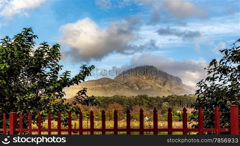 View of the beautiful rocky mountains of Stellenbosch behind a red fence