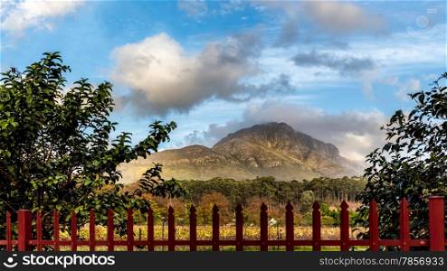 View of the beautiful rocky mountains of Stellenbosch behind a red fence