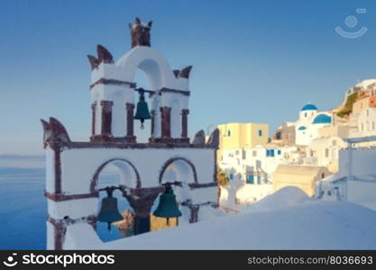 View of the bell tower, blue bay and Kolder. Santorini. Greece.