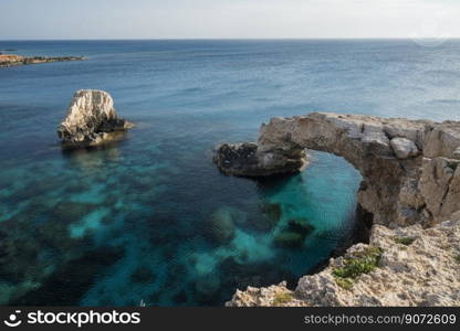 view of the bridge of lovers on the seashore with rocks in ayia napa