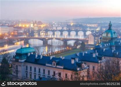 View of the bridge over the Vltava at sunset from a height.. Prague. Bridges over the Vltava at night.