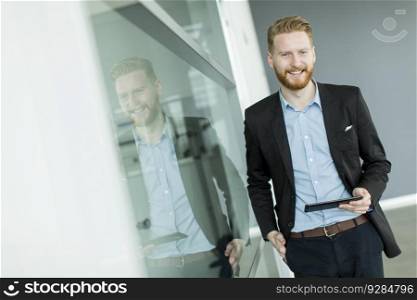 View of the businessman with a tablet in the office