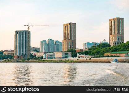 View of the city of Khabarovsk from the Amur river. Urban landscape in the evening at sunset. View of the city of Khabarovsk from the Amur river. Urban landscape in the evening at sunset.