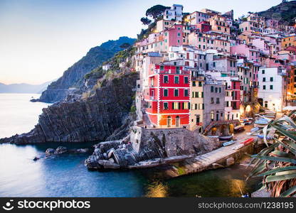 view of the colorful houses along the coastline of Cinque Terre area in Riomaggiore, Italy