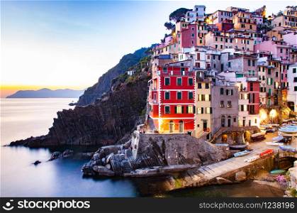 view of the colorful houses along the coastline of Cinque Terre area in Riomaggiore, Italy
