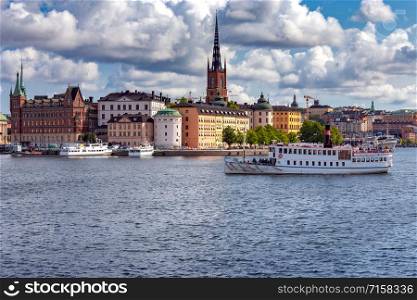 View of the embankment and the historic part of the city on the island Gamla Stan. Stockholm. Sweden.. Stockholm. View of the city embankment of the island of Gamla Stan.