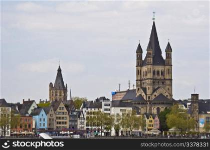 view of the embankment in Cologne and the Great St. Martin church and the townhall