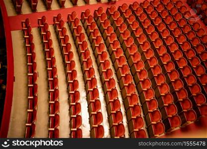 View of the empty parterre in the theatre concert hall of Vienna State Opera auditorium with red seats in the rows without people in Vienna, Austria.. The empty parterre in the concert hall of Vienna State Opera auditorium.