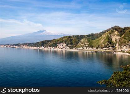 view of the Etna volcano on the Gulf of Taotmina (Italy)