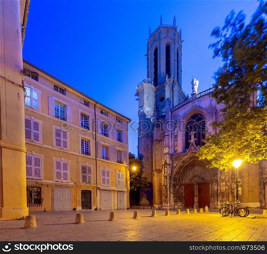 View of the facade of the old Catholic cathedral in the night lighting. France. Provence. Aix-en-Provence.. Aix-en-Provence. The facade of the old catholic cathedral at sunrise.