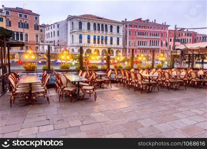 View of the Grand Canal and the city in the night light at sunset. Venice. Italy.. Venice. Grand Canal at sunset.