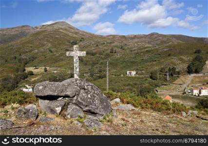 View of the granite cross on top of the hill near the mountain chapel in the Peneda National Park, Northern Portugal