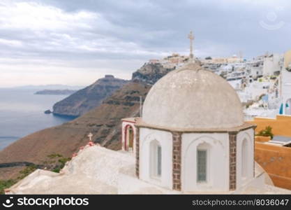 View of the Greek Christian church with a cross in the town Fira. Santorini. Greece.. Fira. Traditional Greek church.