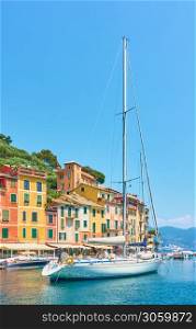 View of the harbour in Portofino with sail boat. Portofino is a luxury resort on the Italian riviera in Liguria, Italy