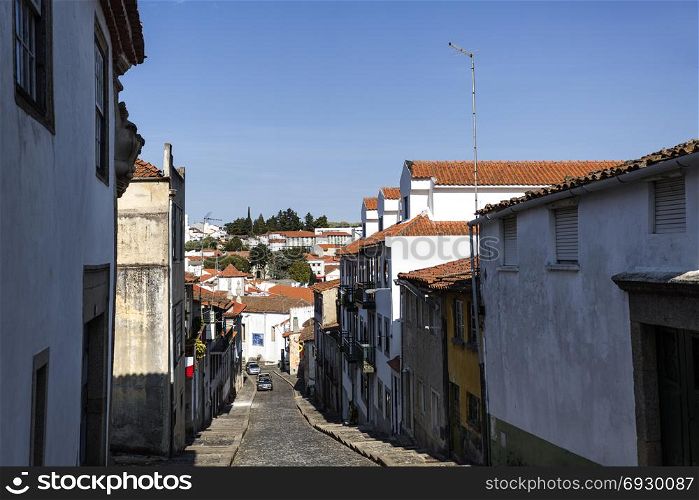 View of the historic centre of Braganca, seen from the castle along an old cobbled street, Portugal