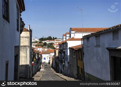 View of the historic centre of Braganca, seen from the castle along an old cobbled street, Portugal