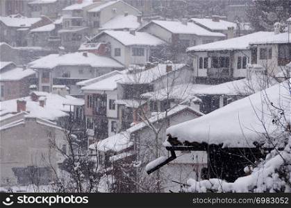 View of the houses and trees on the hill in the winter in the town of Veliko Tarnovo in Bulgaria