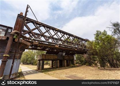View of the iron rail bridge over the Macquarie River built in 1884 and known as the Lattice Railway Bridge in Dubbo, New South Wales, Australia